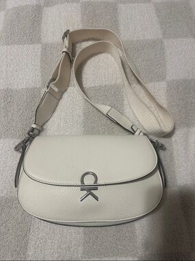 Calvin Klein Cream Pebbled Leather Crossbody Saddle Bag with Silver Logo
